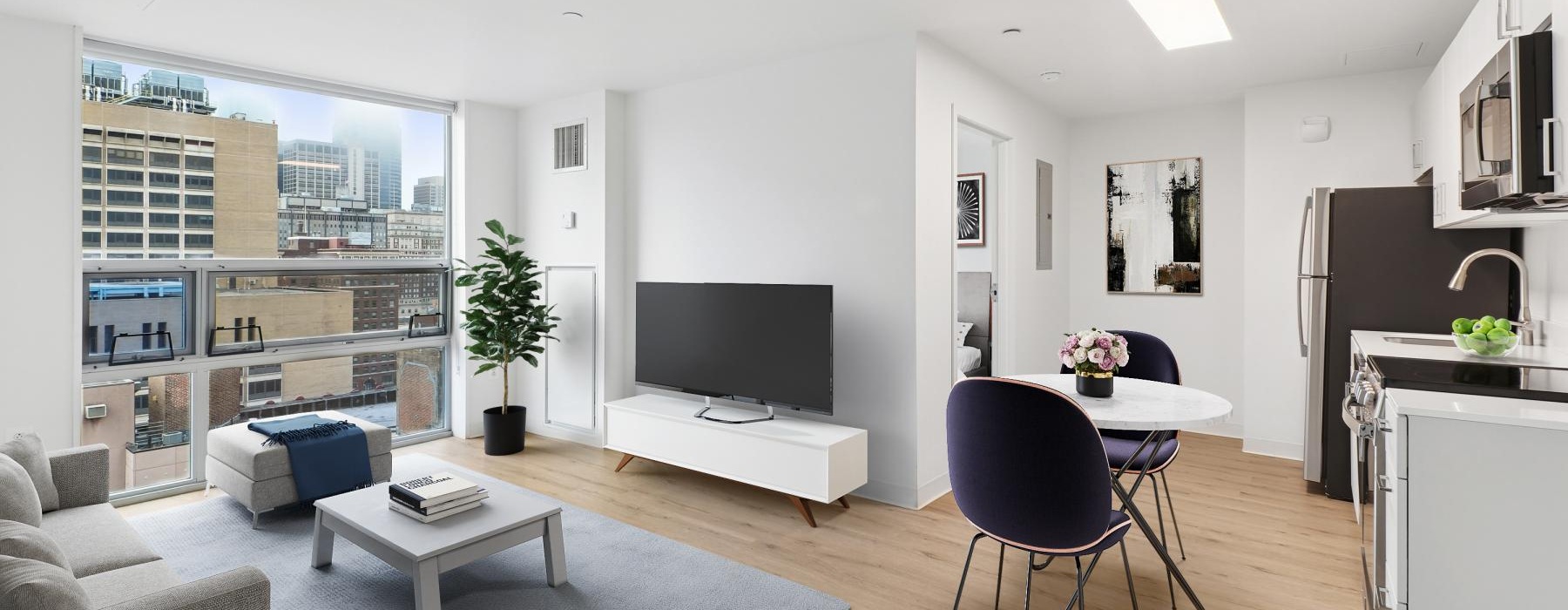 a living room with a tv and chairs